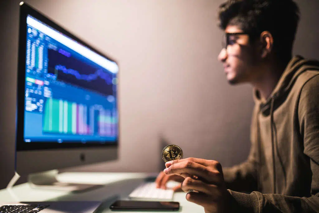 indian bitcoin trader checking stock trading data analysis concept working office with financial graph computer monitors 1